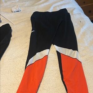 Three pairs of workout pants. One pair of medium and two pairs of two.